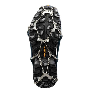 Snowline crampons attached to the sole of a hiking boot