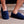 Person wearing navy blue SnugToes fleece slippers