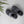 Pair of grey plush SnugToes slippers on a light wood floor