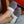 Grey faux fur slippers with white fleece lining worn on feet