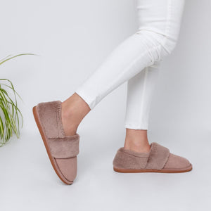 SnugToes taupe faux fur slippers worn with white trousers