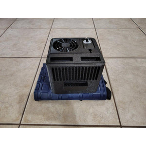 Mattress Cooler unit with black fan housing and control dial on a blue cooling pad