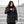 Person wearing black ActionHeat Philadelphia Eagles heated jacket pointing to the power button