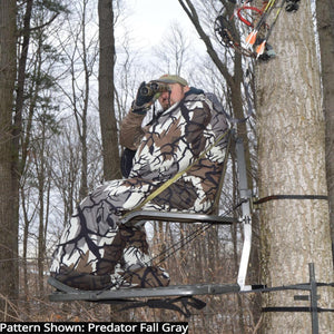 Hunter in a Heater Body Suit using binoculars in a tree stand