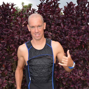 Man wearing a black HyperKewl cooling vest with blue trim