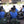 Group of people wearing TechKewl blue cooling vests sitting on the ground