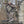 Hunter wearing a Heater Body Suit in Mossy Oak Breakup Country camo pattern while aiming a compound bow in a tree stand