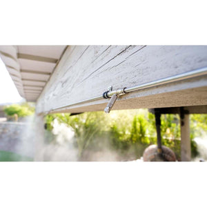The Patio Misting System nozzle mounted on a wooden beam spraying a fine mist