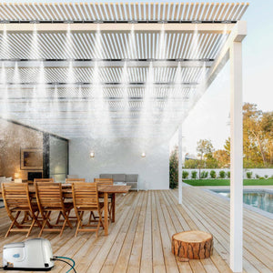 Patio Misting System installed on a wooden pergola over a deck with dining furniture