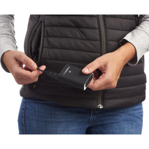 Person plugging a Therm-ic power bank into a heated vest pocket