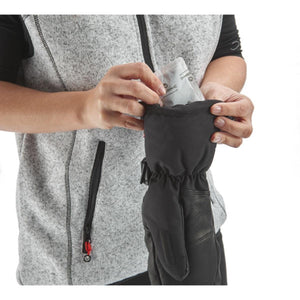 Person inserting a Therm-ic heat pack into a black winter glove