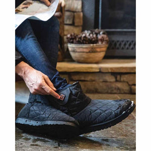 Person adjusting ThermalStep black quilted ankle boot