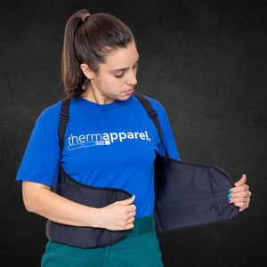 Person wearing a black ThermApparel cooling vest over a blue t-shirt