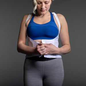 Person wearing a white ThermApparel cooling vest over a blue sports bra