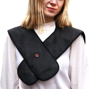 Person wearing a black Thermup heated neck wrap over a white sweater