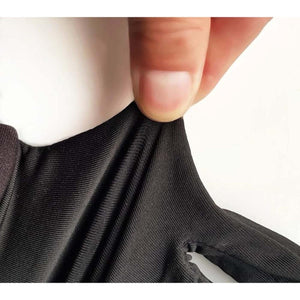 Close up of fingers stretching black ribbed fabric