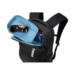 Thule backpack with open top compartment containing sunglasses