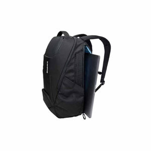 Thule black backpack with a laptop partially inserted into the side compartment