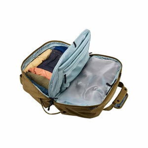 Open Thule travel backpack showing internal compartments with folded clothing and a clear storage pocket