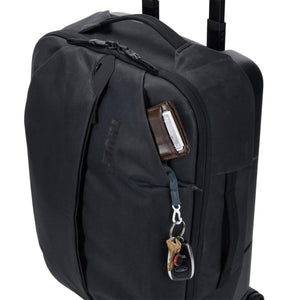 Thule black rolling luggage with wallet and keys in the front pocket