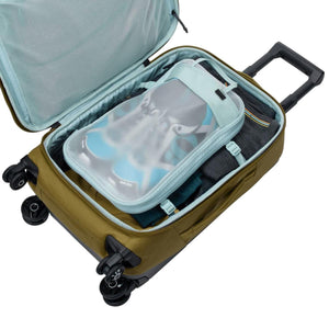 Open Thule carry-on luggage containing packed clothing and a shoe storage cube