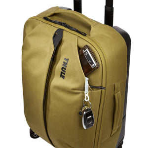 Thule olive green carry-on luggage with wallet and keys in the front pocket