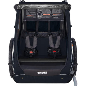 Thule double child carrier with five point safety harnesses and warning labels