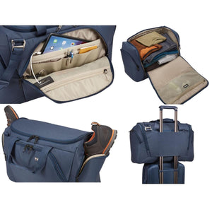 Thule blue duffel bag showing interior pockets, packed clothes, shoe compartment, and luggage handle pass-through