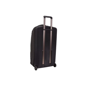 Back view of a black Thule rolling carry on luggage with extended handle