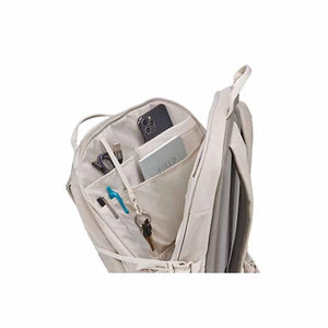 Open Thule backpack showing internal organizer pockets with phone notebook pens and keys