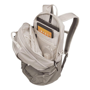 Open Thule backpack showing internal laptop and tablet compartments with mesh pockets