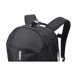Black Thule backpack with sunglasses resting on the top handle