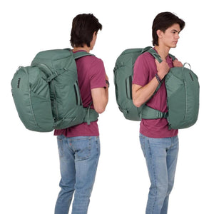 Man wearing a green Thule travel backpack with a detachable daypack on his back and front