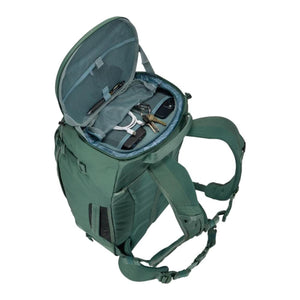 Thule green backpack with open top compartment showing mesh pockets and organized accessories