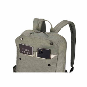 Thule backpack with front pocket containing a Field Notes notebook and a smartphone