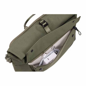 Thule olive green bag showing an open front pocket containing a white power adapter and charging cable