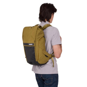 Person wearing an olive green Thule rolltop backpack