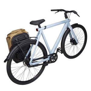 Light blue bicycle with a tan and black pannier bag attached to the rear rack