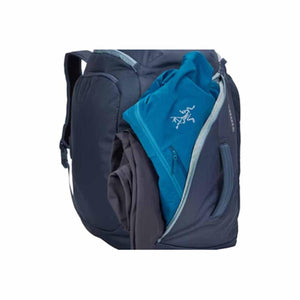 Arc teryx backpack side pocket with blue jacket and grey clothing inside