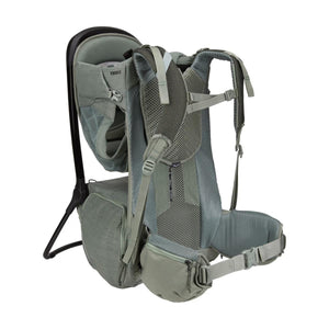 Thule child carrier backpack in sage green with adjustable straps and padded waist belt