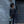 Person standing by a door holding a Thule travel bag