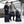 Man and woman standing with various Thule black luggage pieces and backpacks