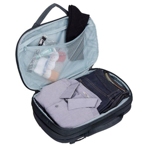 Open Thule travel bag with folded shirt and jeans inside