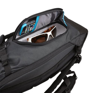 Thule backpack top compartment containing a smartphone and sunglasses