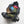 Open black hiking backpack packed with colorful gear and sleeping bags