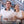 Man and woman wearing portable neck fans while walking outdoors