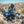 Rider wearing Tourmaster jacket and helmet on a blue Yamaha motorcycle in a rocky desert landscape