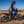 Motorcyclist wearing Tourmaster riding gear on a blue Yamaha Tenere motorcycle on a dirt road