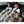 Two children sitting in a car backseat covered by a faux fur throw blanket