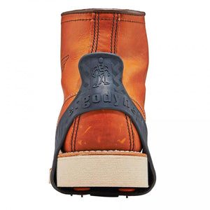 Trex traction cleat attached to the heel of a brown leather work boot